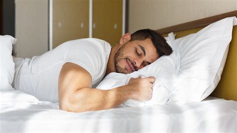 guy sleeping stock image|man laying on bed.